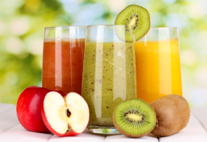 Apple, Kiwi and Orange fruit and Fruit Juices in Glasses